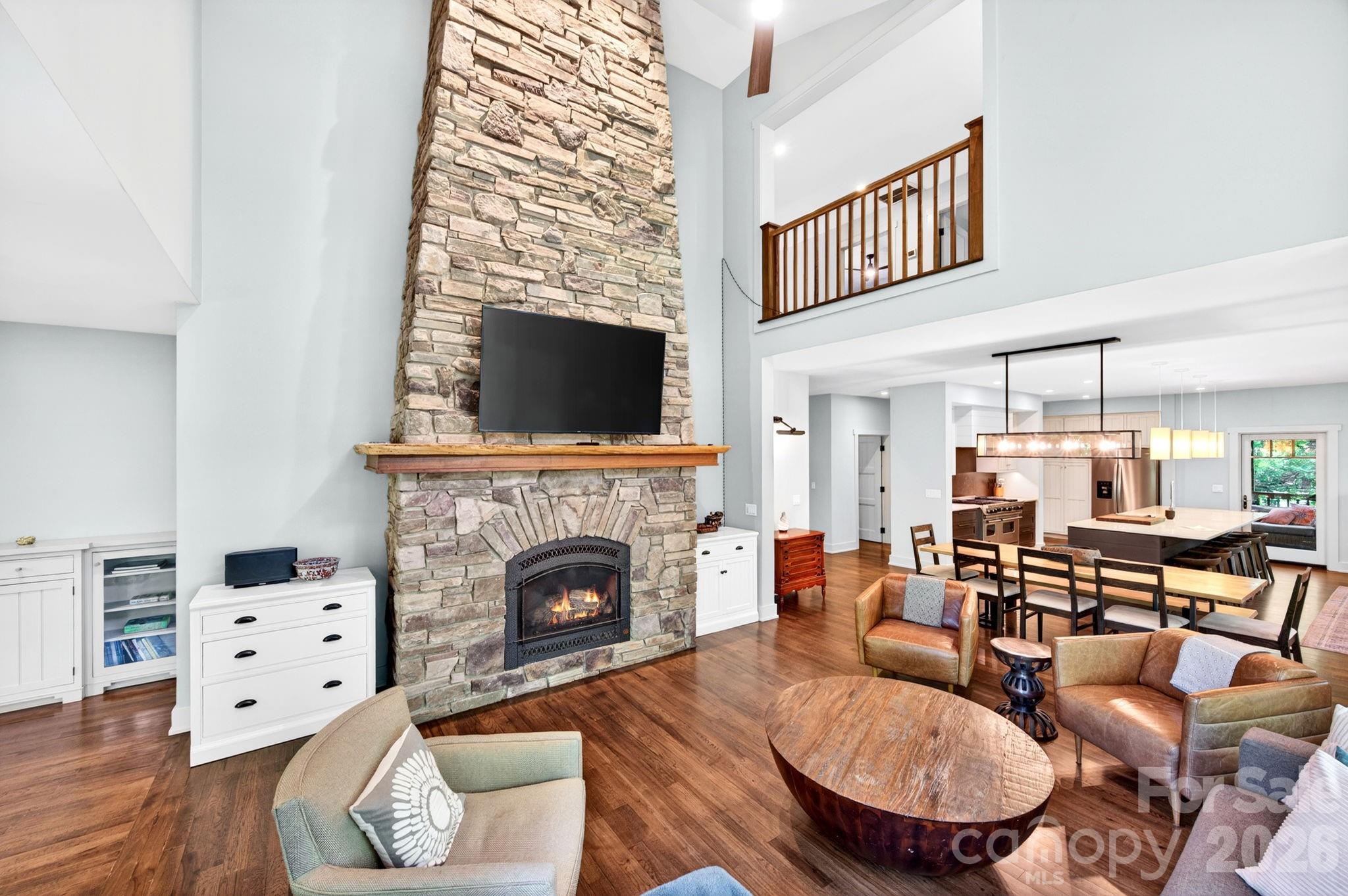 235 Bull Creek Road Asheville, NC 28805 - Photo 5 of 47 a living room with furniture a fireplace and a flat screen tv