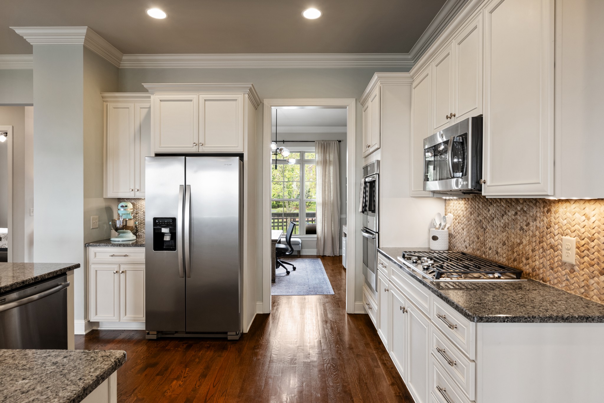 148 Truman Road West Franklin, TN 37064 - Photo 12 of 42 a kitchen with stainless steel appliances granite countertop a refrigerator a stove and a wooden floors