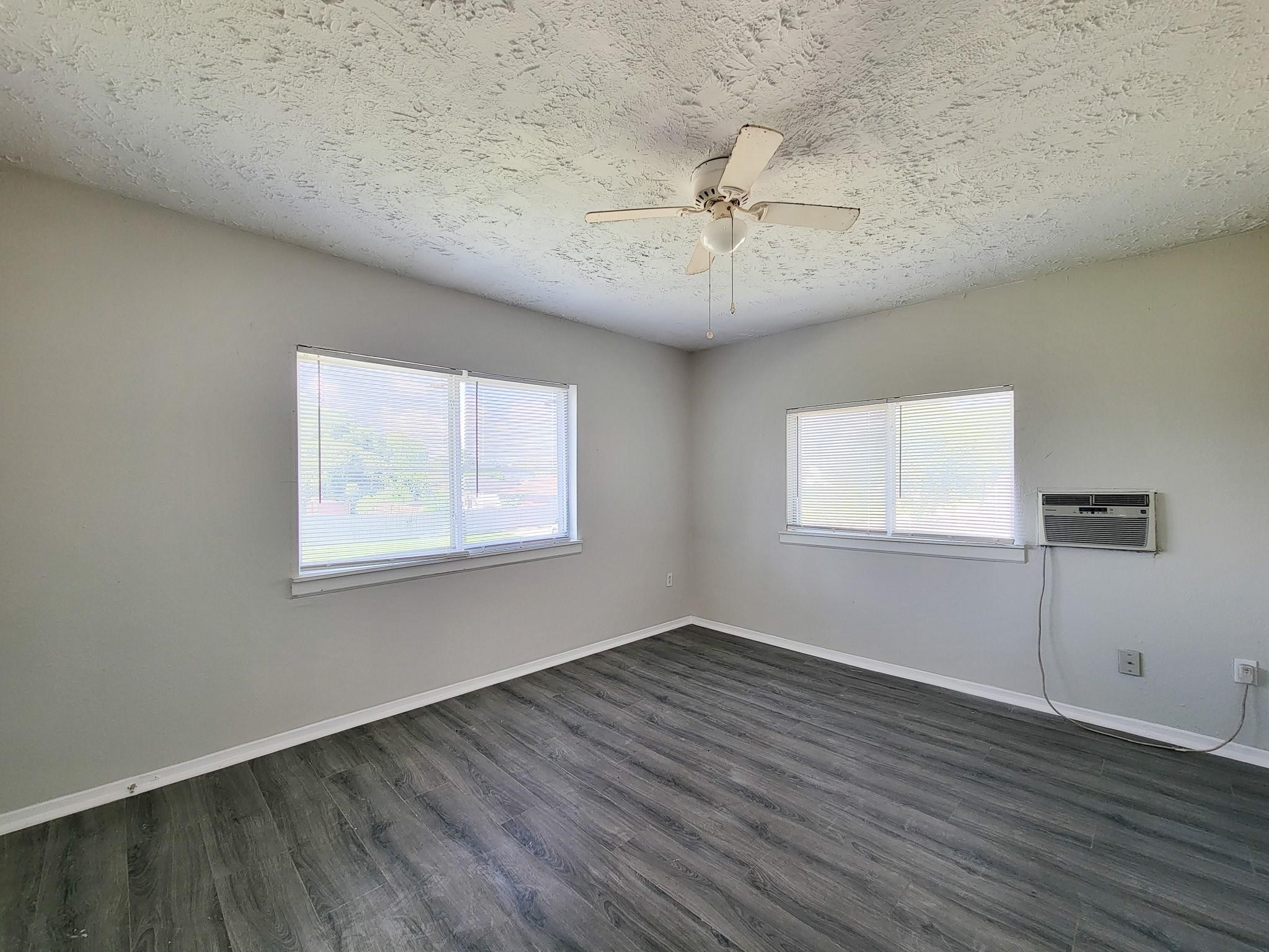 711 Ave A, Unit 4 La Marque, TX 77568 - Photo 4 of 21 a view of a big room with wooden floor and windows