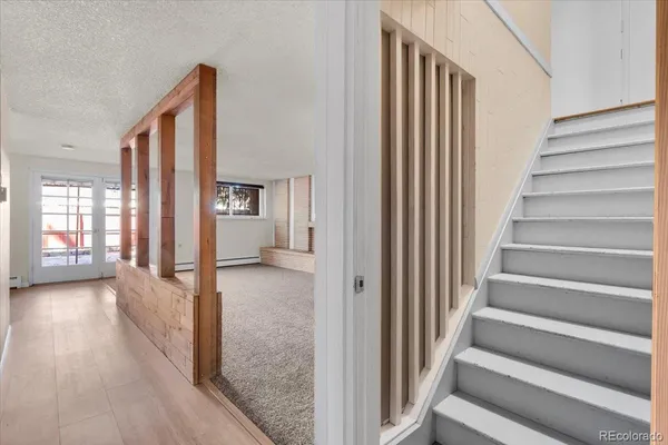 a view of a hallway with wooden floor and entryway