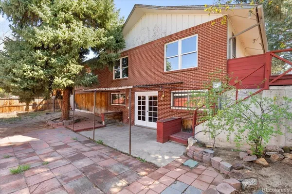a front view of a house with a yard and seating space