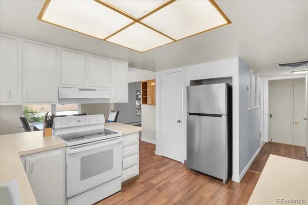 a kitchen with a refrigerator sink and cabinets