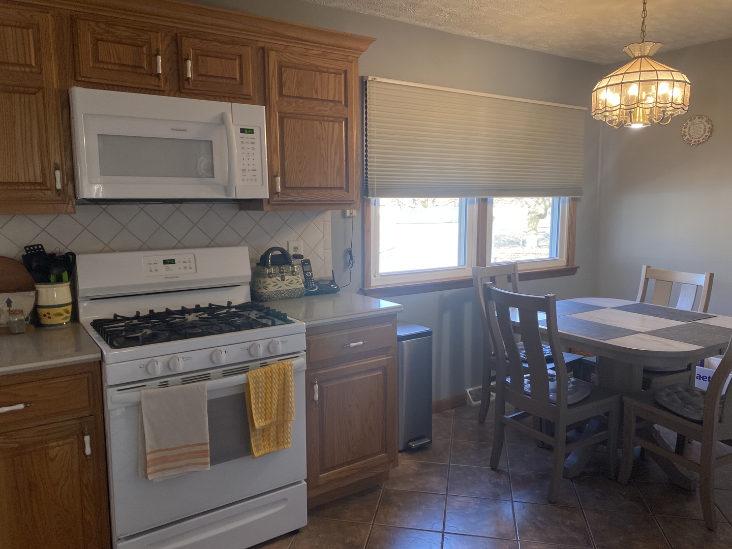 19 Capri Street Streator, IL 61364 - Photo 9 of 35 a kitchen with stainless steel appliances granite countertop a stove a sink and a microwave
