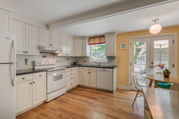 100 Mayflower Road Needham, MA 02492 - Photo 13 of 28 a kitchen with sink cabinets and wooden floor
