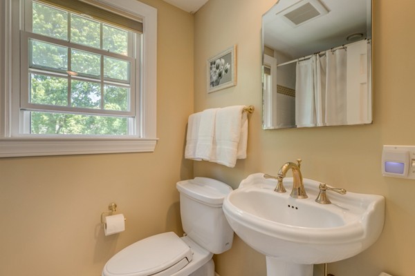 100 Mayflower Road Needham, MA 02492 - Photo 20 of 28 a bathroom with a sink a mirror and a toilet