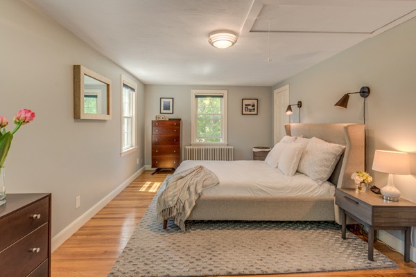 100 Mayflower Road Needham, MA 02492 - Photo 21 of 28 a bedroom with a bed and a lamp on the dresser