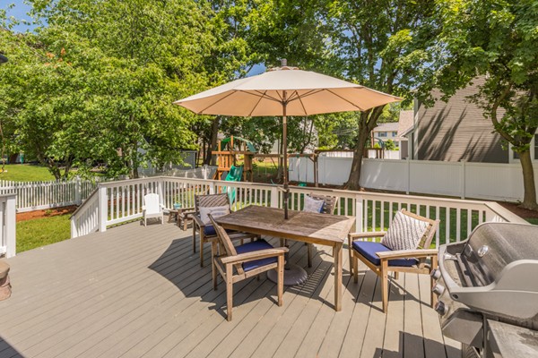 100 Mayflower Road Needham, MA 02492 - Photo 24 of 28 a patio with wooden floor a yard a table and chairs