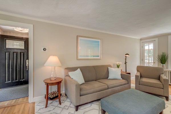 100 Mayflower Road Needham, MA 02492 - Photo 8 of 28 a living room with furniture and a lamp
