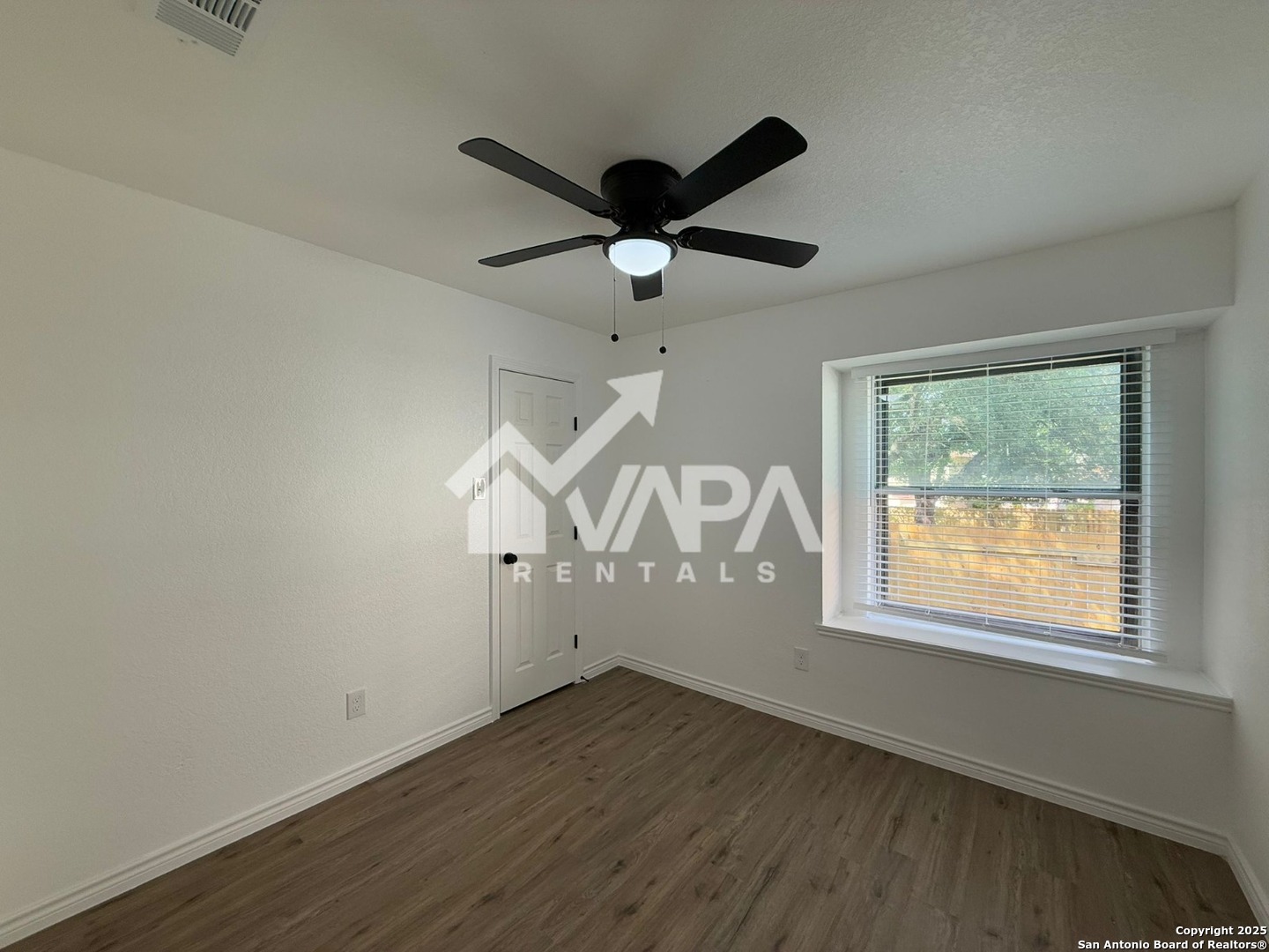 6406 Gray Ridge San Antonio, TX 78233 - Photo 11 of 15 a view of an empty room with wooden floor and a window