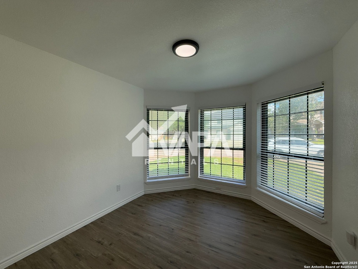 6406 Gray Ridge San Antonio, TX 78233 - Photo 3 of 15 an empty room with wooden floor and windows