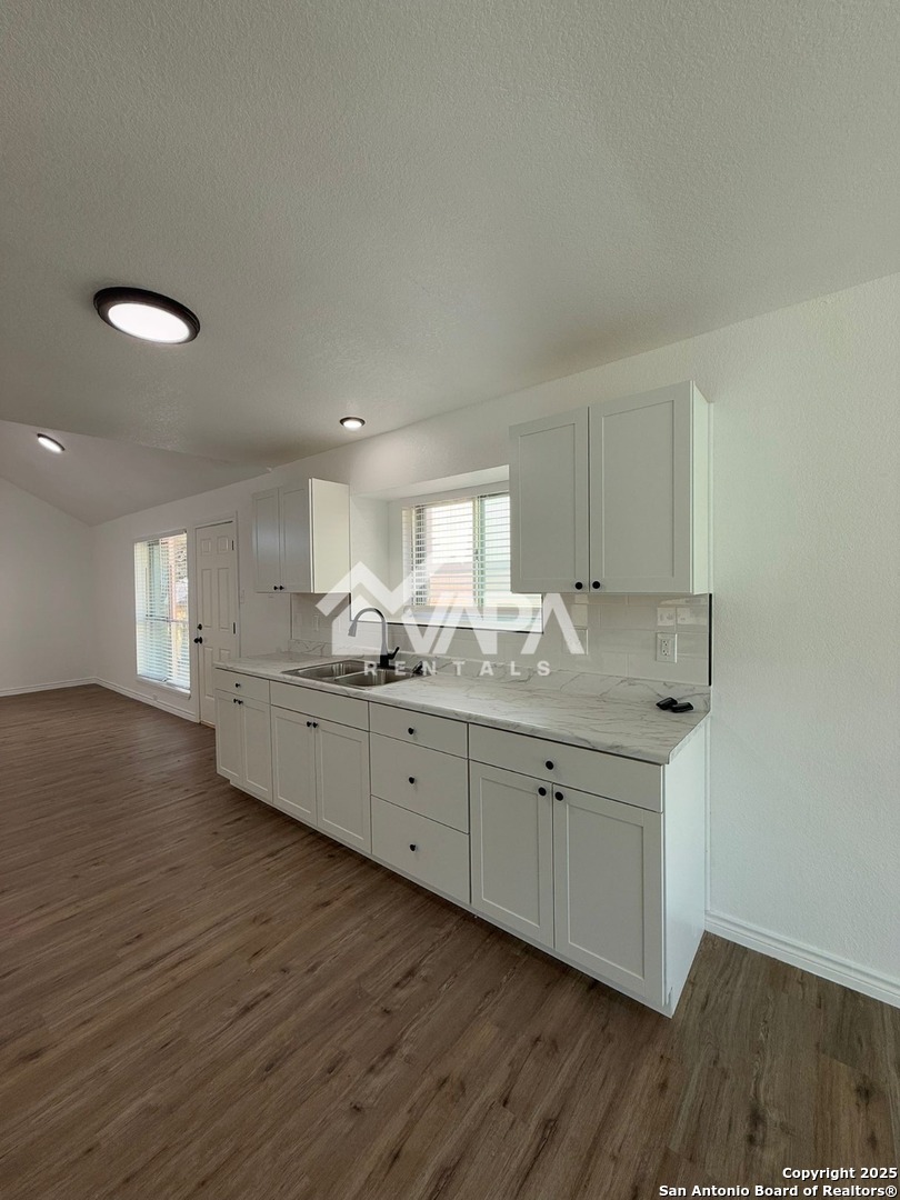 6406 Gray Ridge San Antonio, TX 78233 - Photo 4 of 15 a kitchen with granite countertop a sink and cabinets