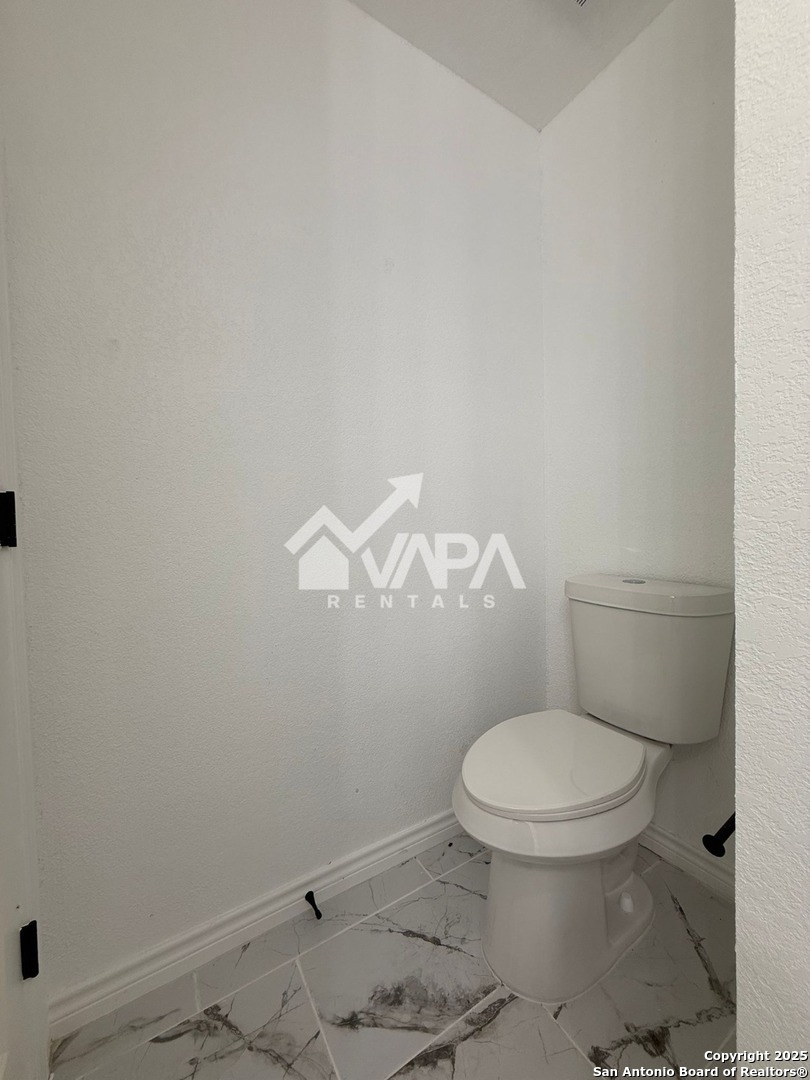 6406 Gray Ridge San Antonio, TX 78233 - Photo 7 of 15 a white toilet sitting next to a shower
