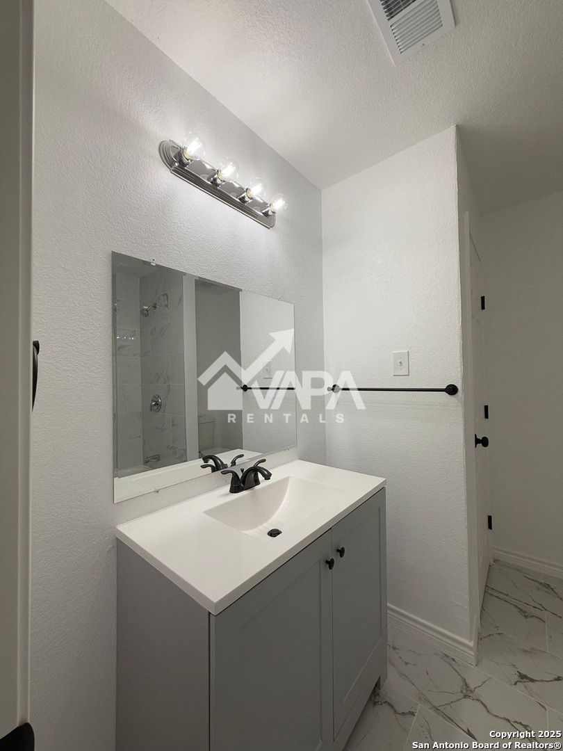6406 Gray Ridge San Antonio, TX 78233 - Photo 9 of 15 a bathroom with a sink and a mirror