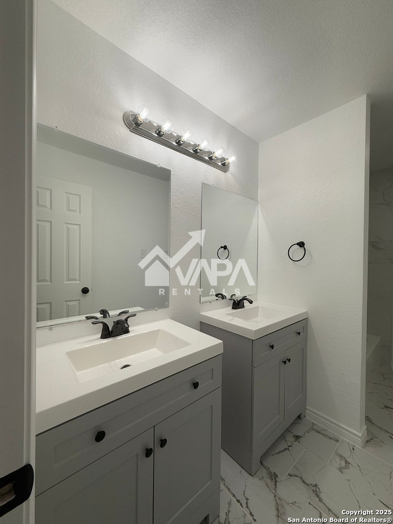 6406 Gray Ridge San Antonio, TX 78233 - Photo 10 of 15 a bathroom with a sink double vanity and a mirror