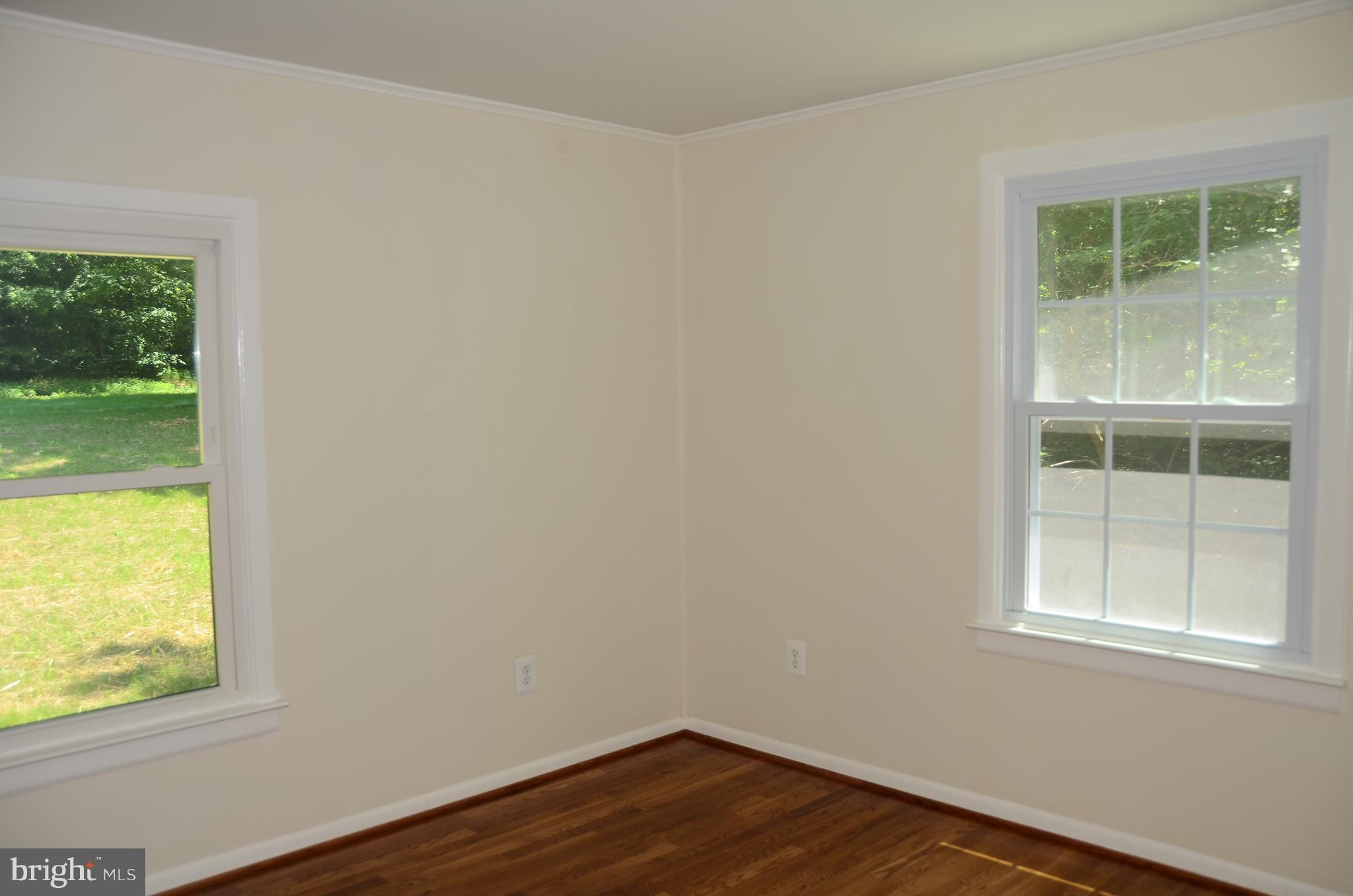 4750 Hardesty Road Huntingtown, MD 20639 - Photo 12 of 26 a view of an empty room with wooden floor and a window