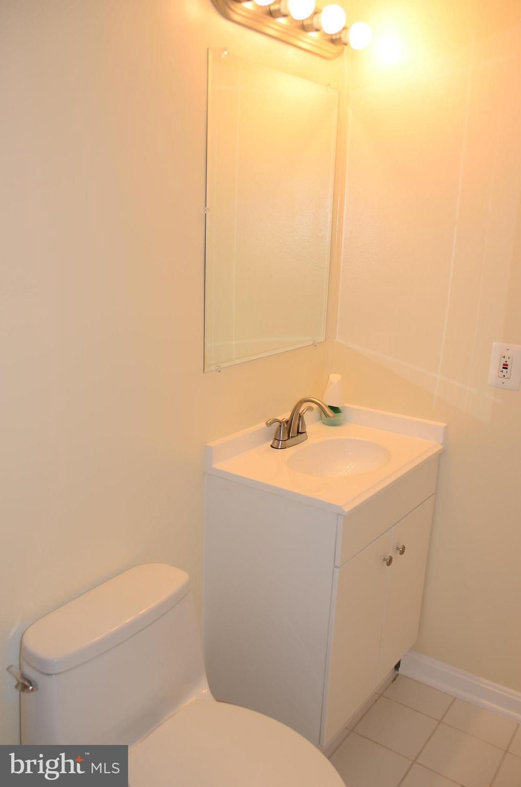 4750 Hardesty Road Huntingtown, MD 20639 - Photo 17 of 26 a bathroom with a sink a toilet and mirror