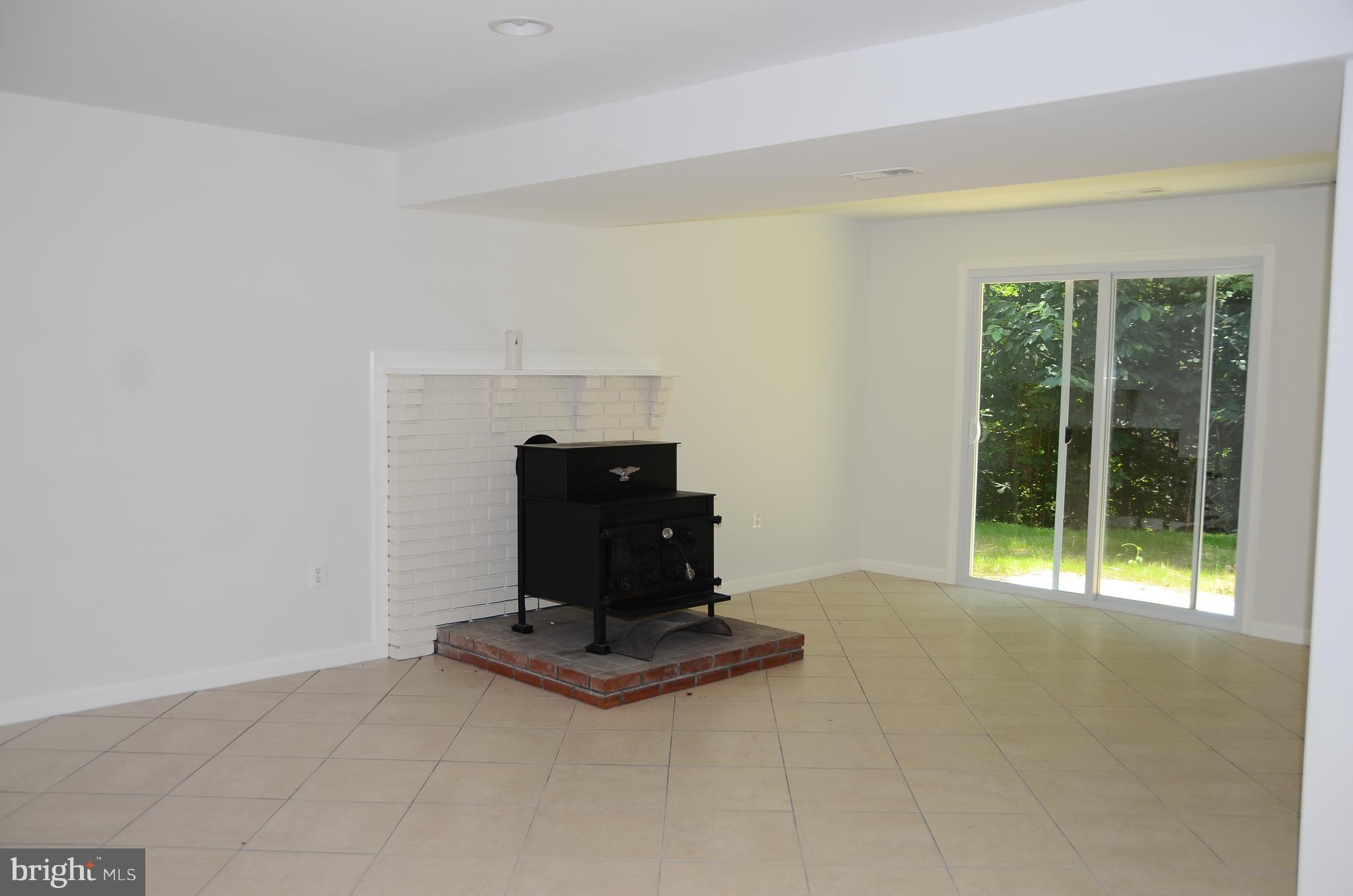 4750 Hardesty Road Huntingtown, MD 20639 - Photo 20 of 26 a living room with a fireplace