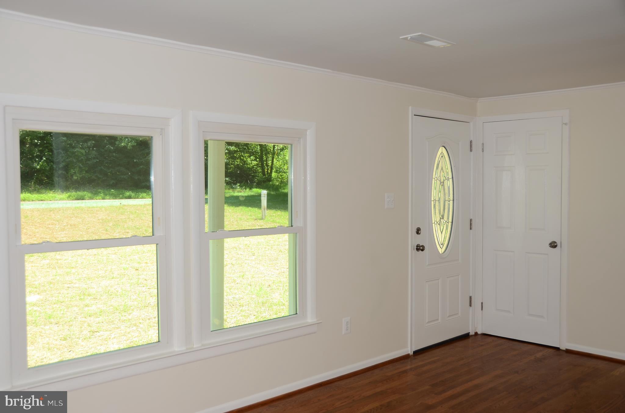 4750 Hardesty Road Huntingtown, MD 20639 - Photo 4 of 26 a view of an empty room with wooden floor and a window