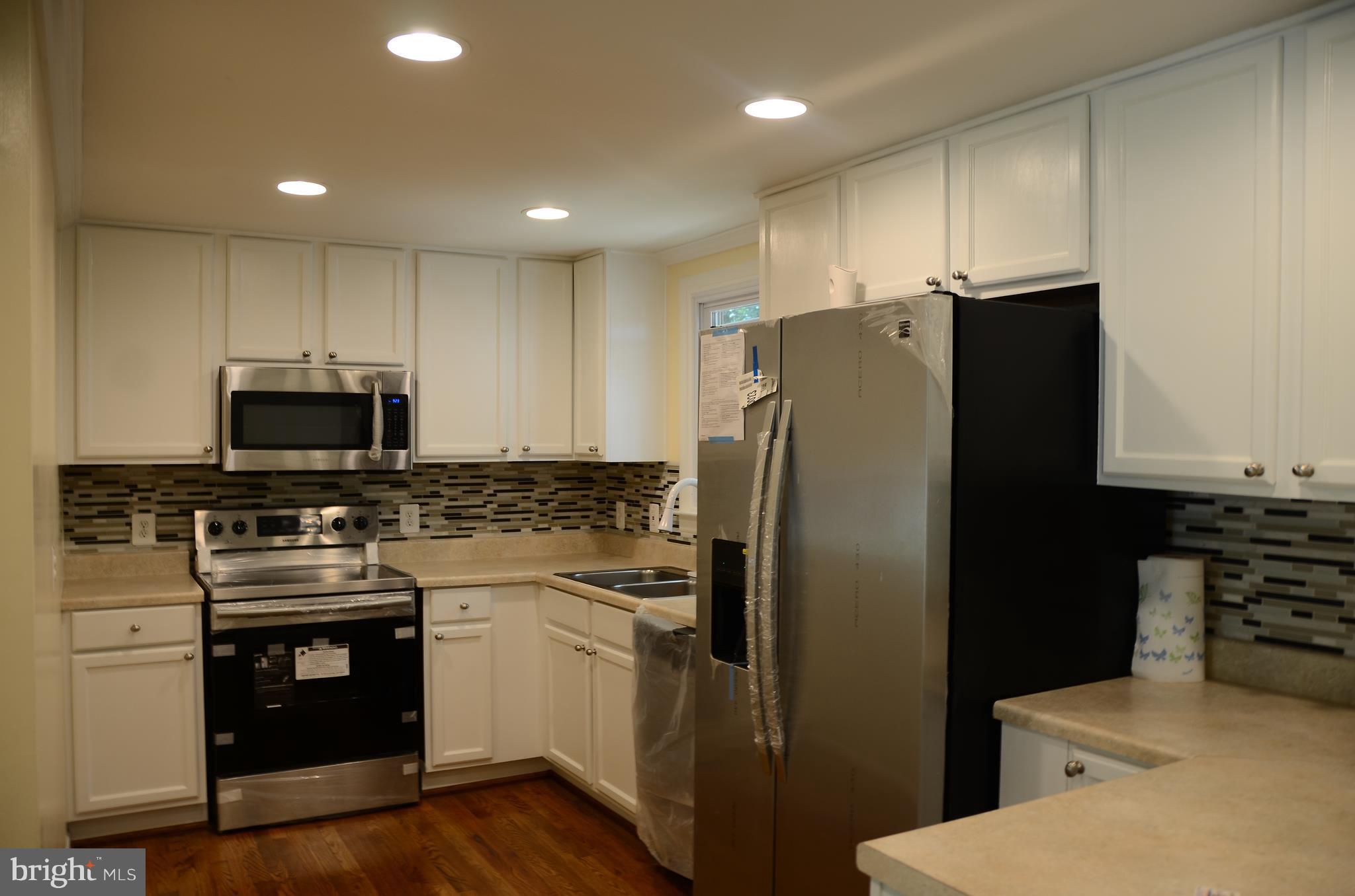 4750 Hardesty Road Huntingtown, MD 20639 - Photo 5 of 26 a kitchen with stainless steel appliances a refrigerator stove and microwave