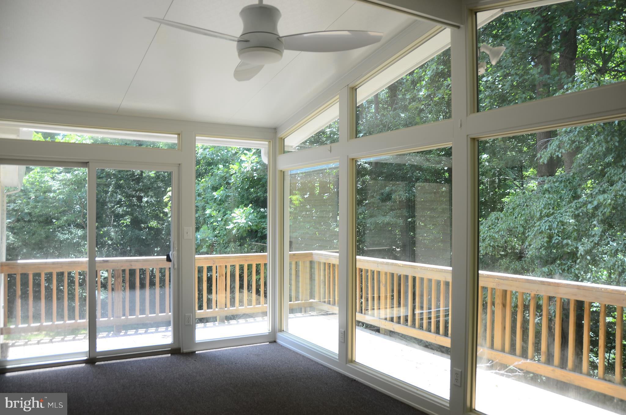 4750 Hardesty Road Huntingtown, MD 20639 - Photo 8 of 26 a view of a porch with a floor to ceiling window
