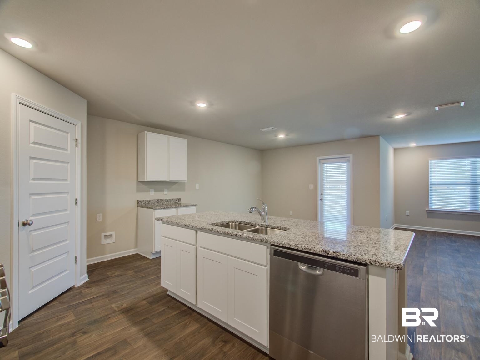23952 Citation Loop Daphne, AL 36526 - Photo 19 of 69 Kitchen with dishwasher, dark wood finished floors, white cabinetry, a kitchen island with sink, and light stone countertops