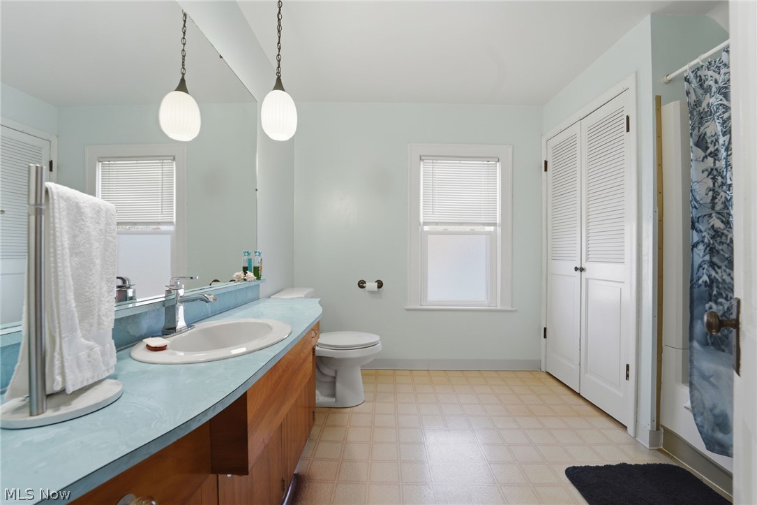 4422 State Road Ashtabula, OH 44004 - Photo 18 of 21 Bathroom featuring a closet, light floors, vanity, and shower / tub combo with curtain