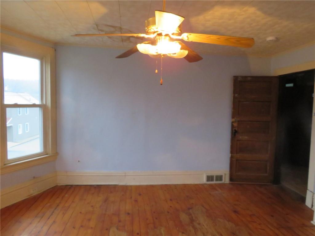 1203 2nd Avenue Conway, PA 15027 - Photo 21 of 43 an empty room with wooden floor and windows