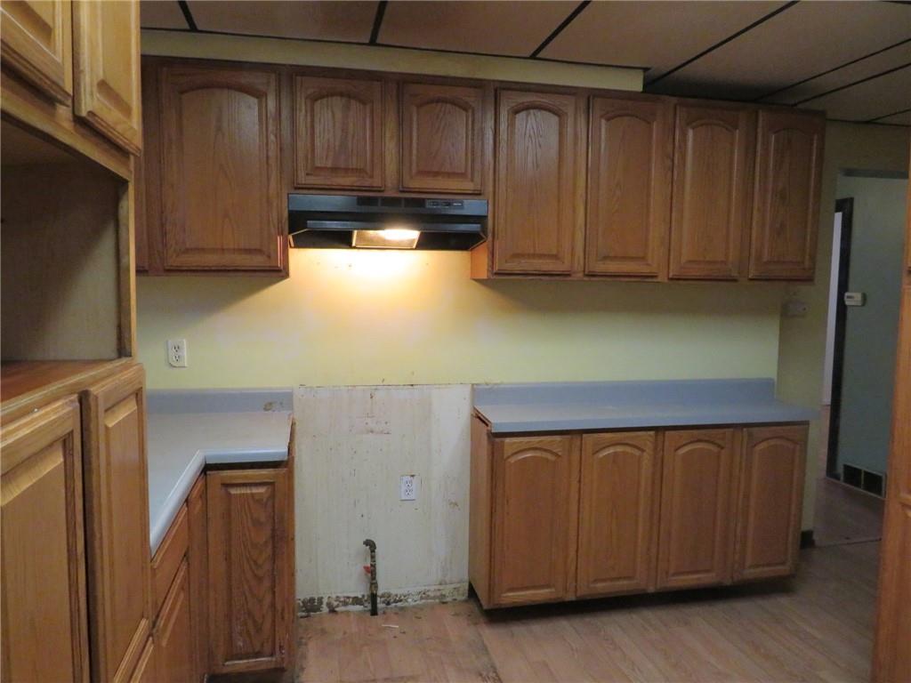 1203 2nd Avenue Conway, PA 15027 - Photo 26 of 43 a kitchen with wooden cabinets and a refrigerator