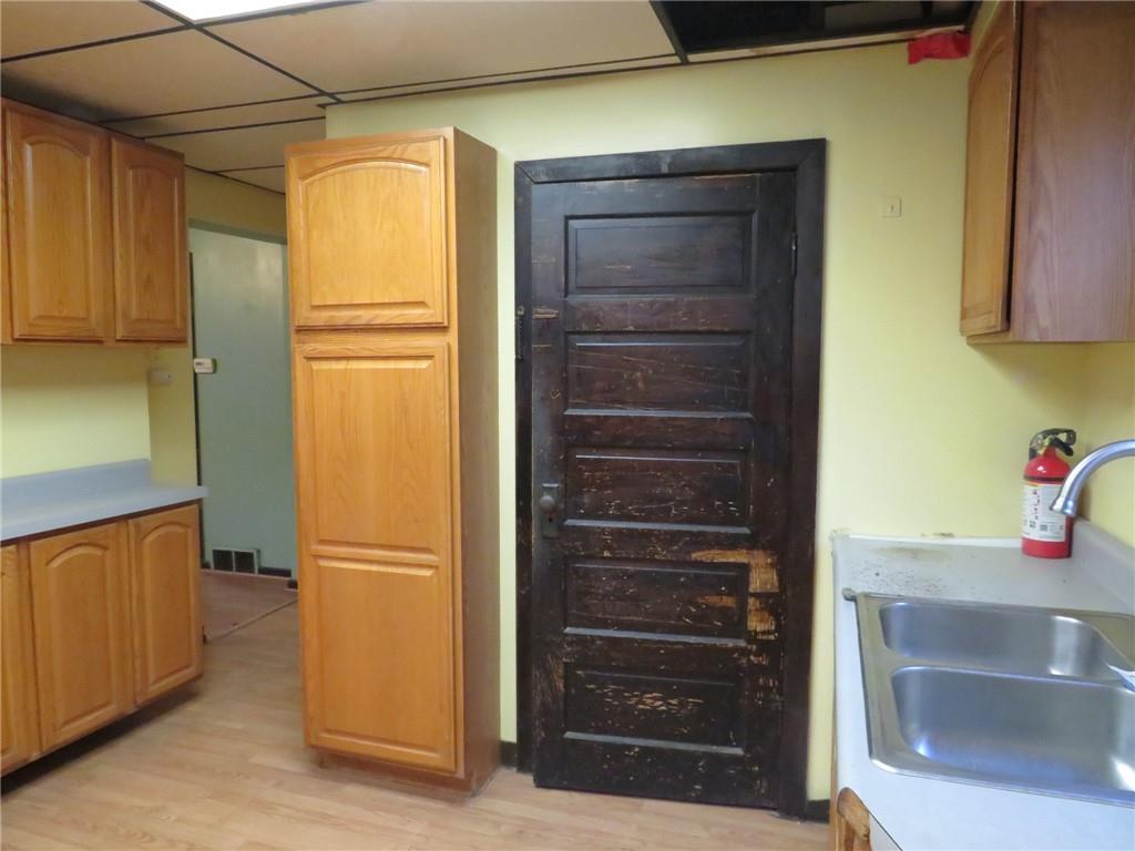 1203 2nd Avenue Conway, PA 15027 - Photo 27 of 43 a kitchen with a refrigerator and cabinets
