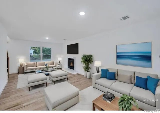 a living room with furniture fireplace and a window