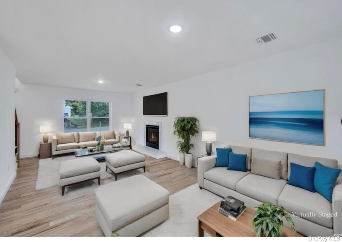34 Huyler Road East Setauket, NY 11733 - Photo 4 of 11 a living room with furniture fireplace and a window
