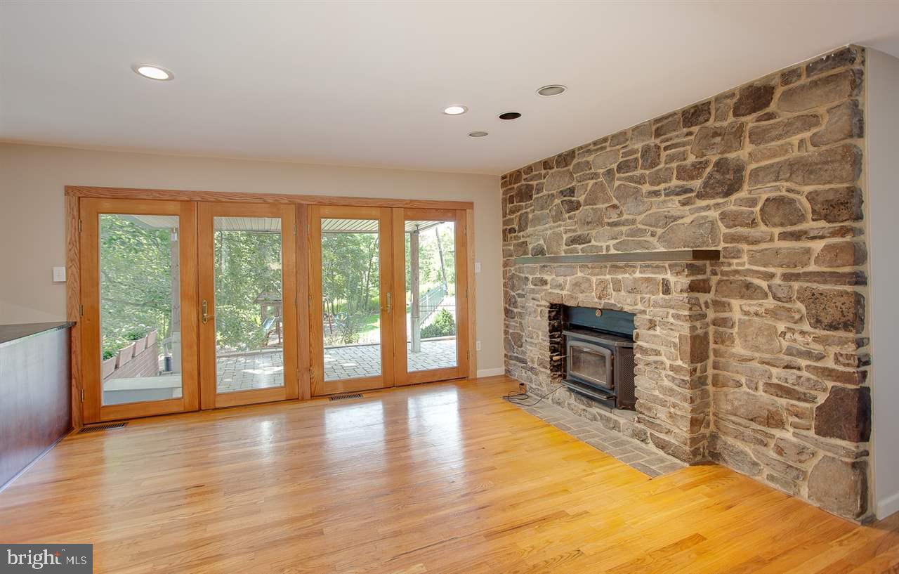 4720 Pine Ridge Road Harrisburg, PA 17110 - Photo 7 of 25 Family Room with patio doors and stone fireplace