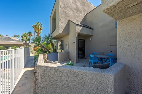 a view of a house with backyard and sitting area