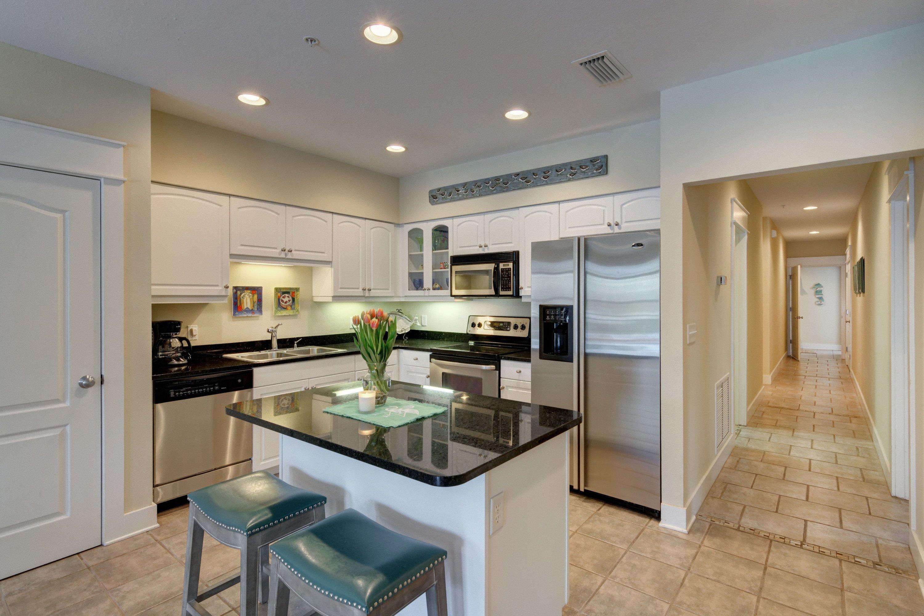 5 Seacrest Blvd Inlet Beach, Unit B201 Inlet Beach, FL 32461 - Photo 14 of 38 a kitchen with granite countertop stainless steel appliances a refrigerator a stove top oven a sink dishwasher and refrigerator