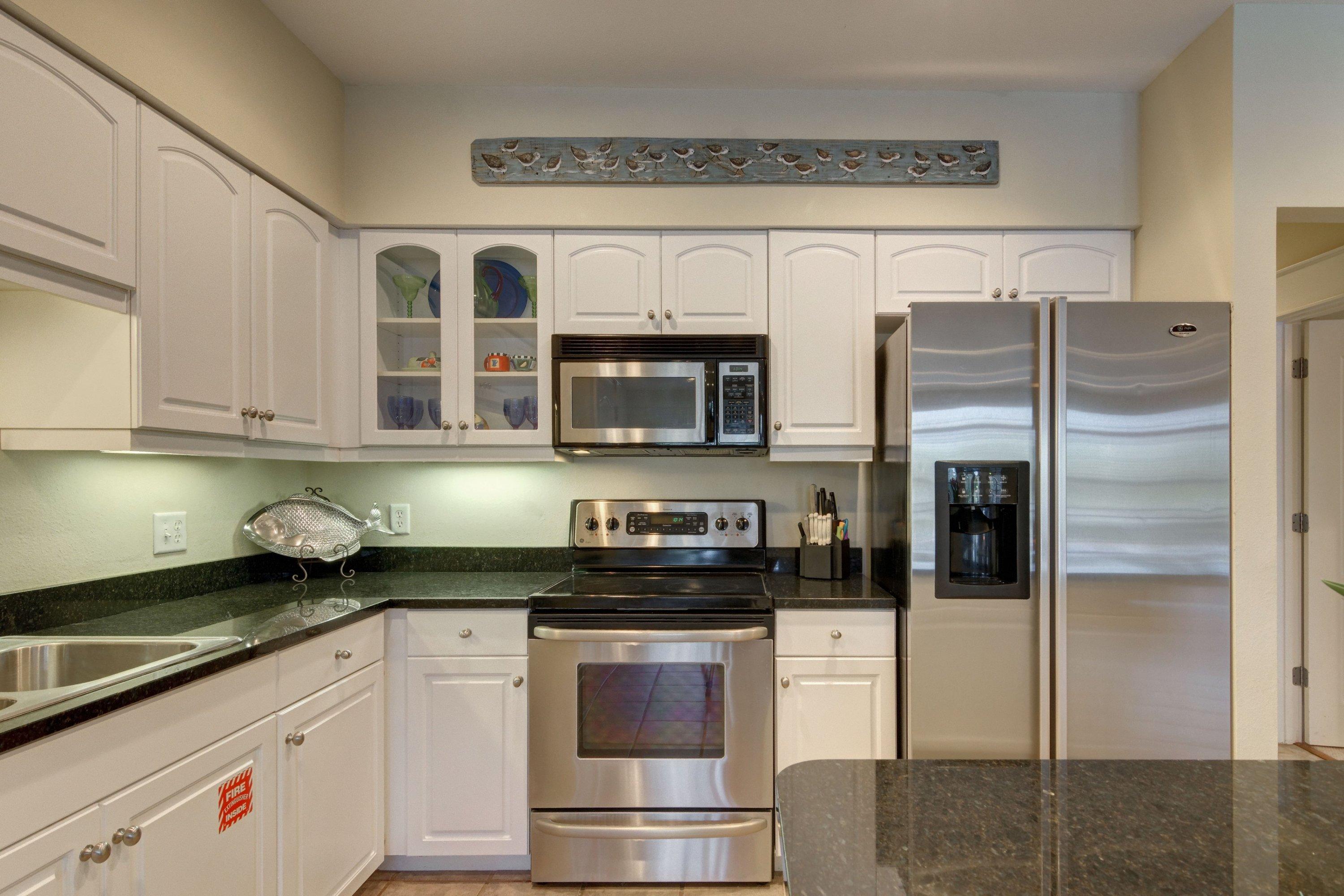 5 Seacrest Blvd Inlet Beach, Unit B201 Inlet Beach, FL 32461 - Photo 15 of 38 a kitchen with stainless steel appliances granite countertop a refrigerator and a stove