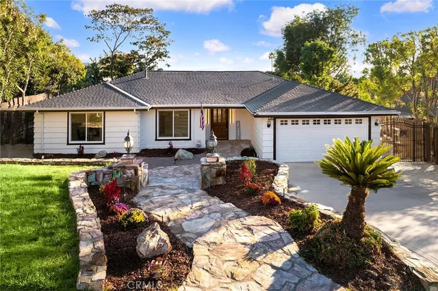 a view of a house with backyard and sitting area