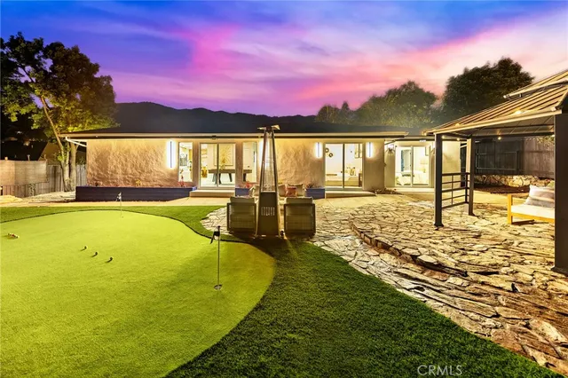 a view of a house with swimming pool and porch with furniture