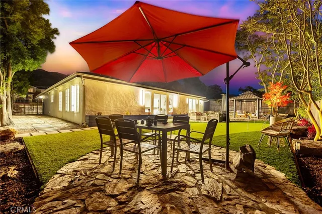 an outdoor space with furniture and umbrella