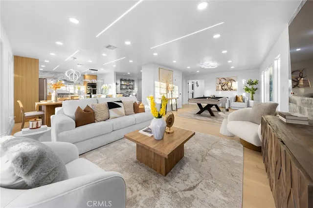 a living room with furniture kitchen view and a table