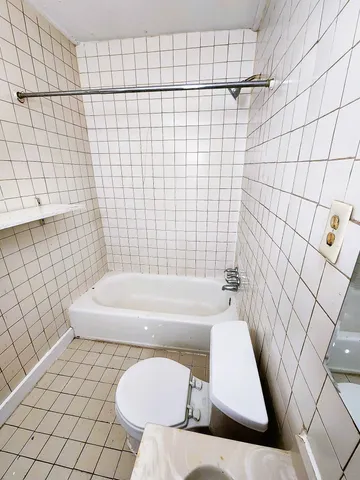 a bathroom with a bathtub and shower