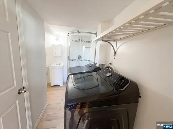 a bathroom with a granite countertop sink mirror vanity and toilet