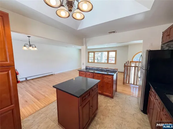 wooden floor with fireplace and windows