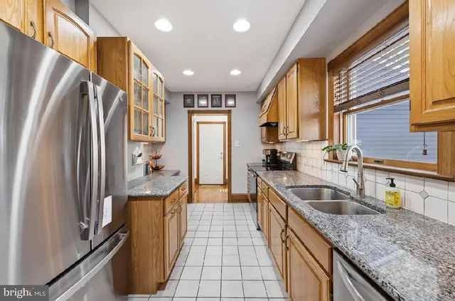 a kitchen with granite countertop sink and cabinets