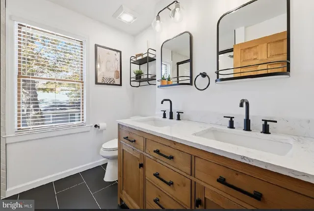 a bedroom with a bed and a ceiling fan