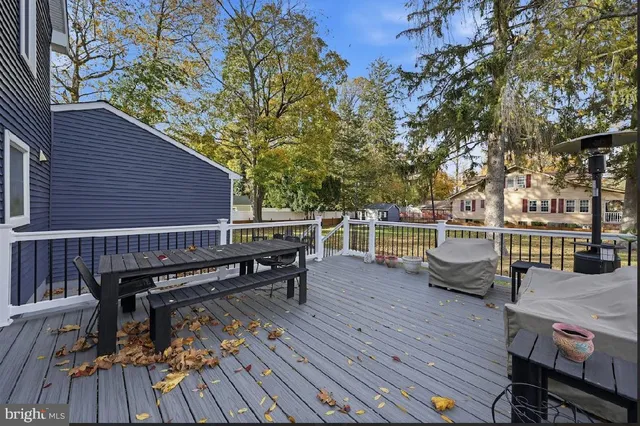 a view of a deck with chairs and wooden fence