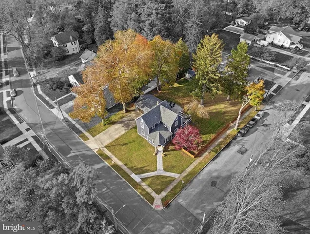 an aerial view of residential houses with yard