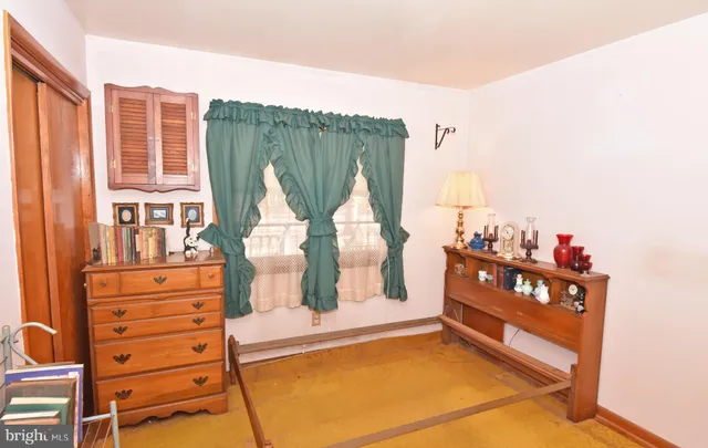 a bed room with furniture and a window