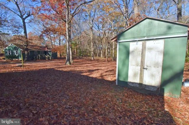 a view of a house with a yard covered in snow