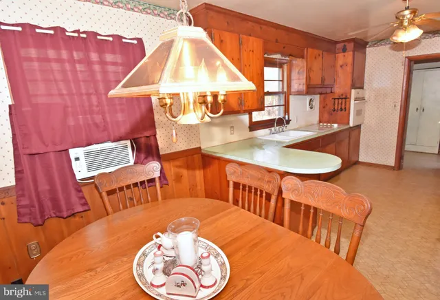a dining room with furniture and a wooden floor