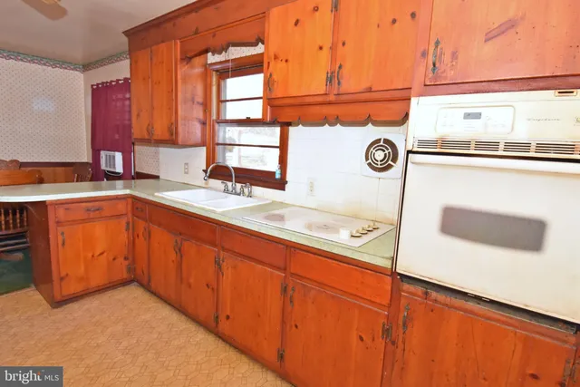 a kitchen with stainless steel appliances granite countertop a sink and a microwave